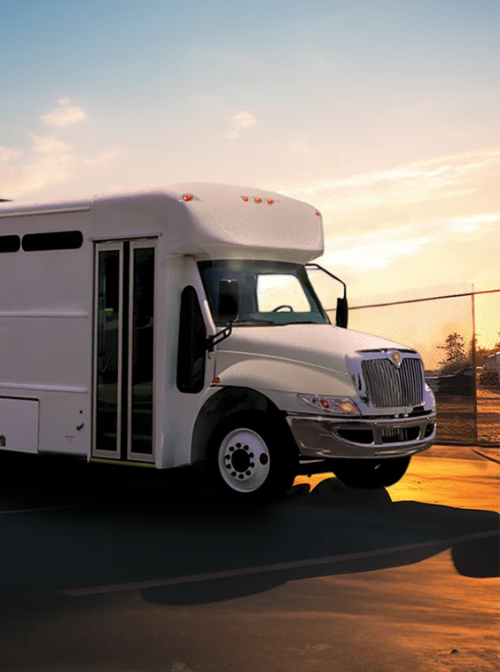 White shuttle bus parked next to a security fence at a prison near Charleston