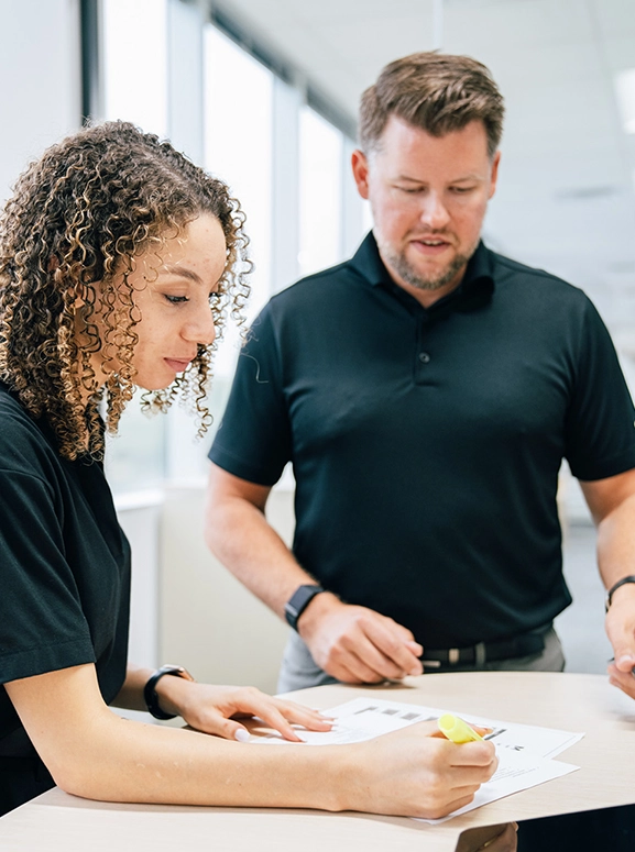 woman and man looking at forms for renting a vehicle in Charleston